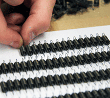 tackboard assembly hand placed in straight rows